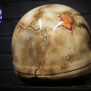 Realistic cracked skull motorcycle helmet design with brown weathered bone texture, orange-red interior details, anatomical airbrush art